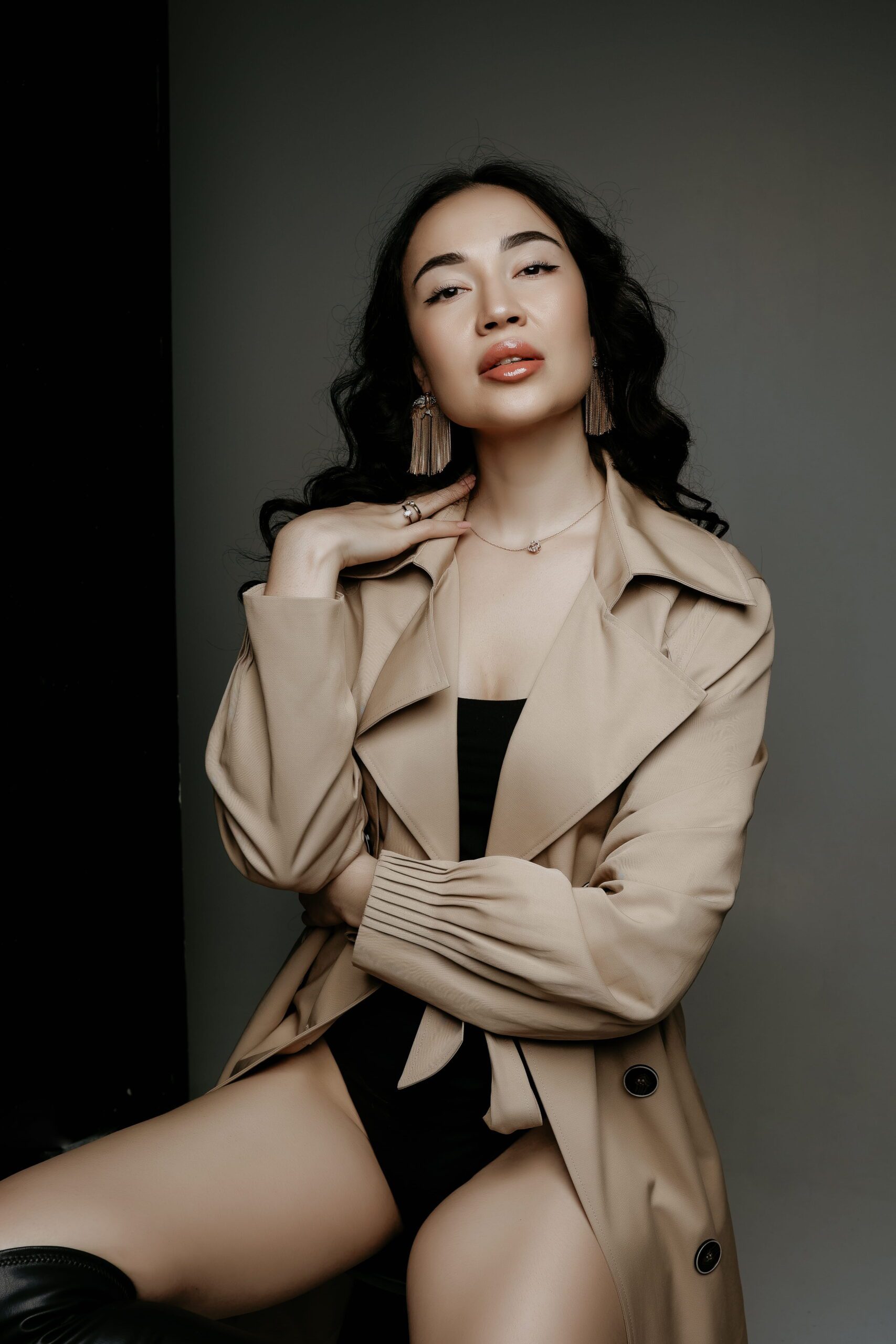 Studio portrait of a woman wearing a tan jacket