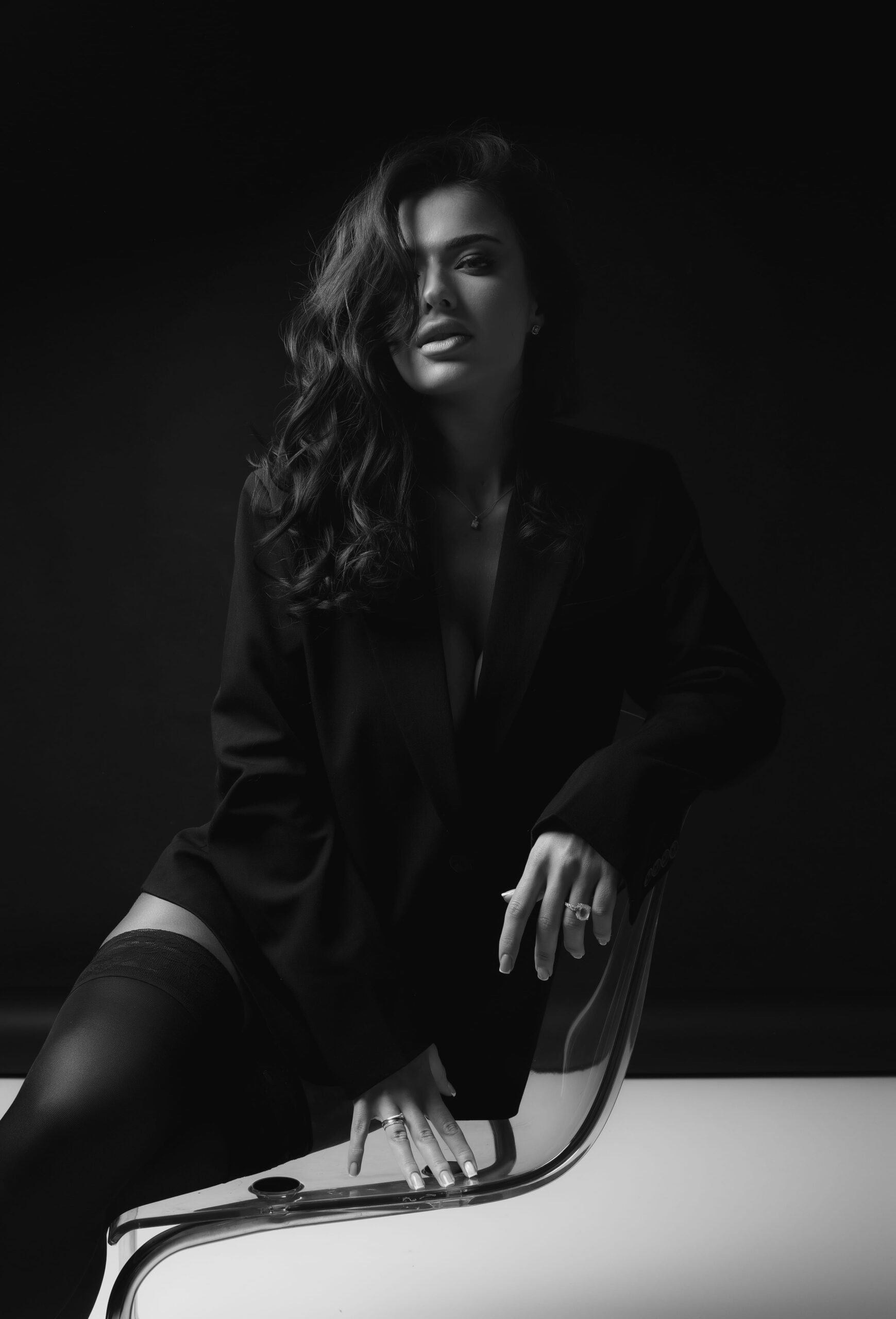 A softly lit monochrome studio portrait