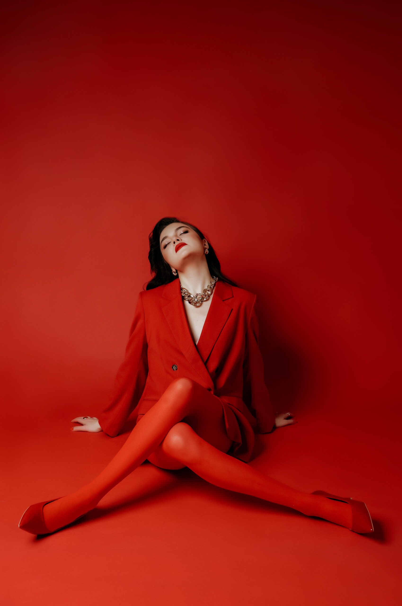A seated fashion portrait in red