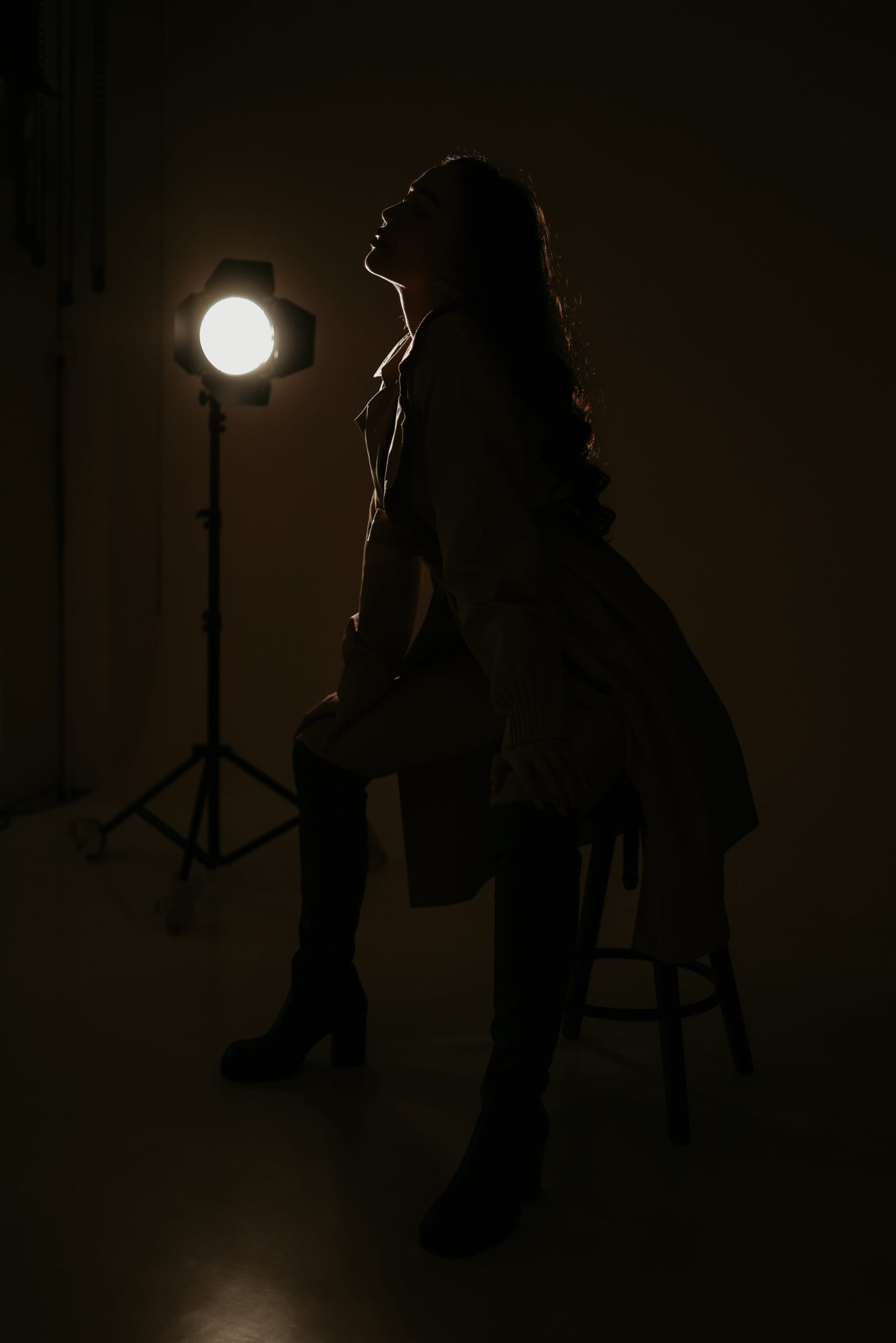 A dark silhouette beside a glowing studio light